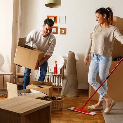 Young couple cleaning and selecting things at they new home.Moving house.